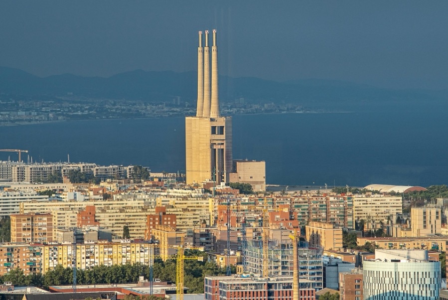 On the horizon, Barcelona’s iconic Three Chimneys stand proudly against the skyline.